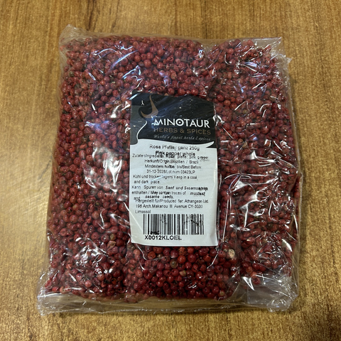 Closeup of a Big Plastic Bag filled with small, round, dried red peppers.