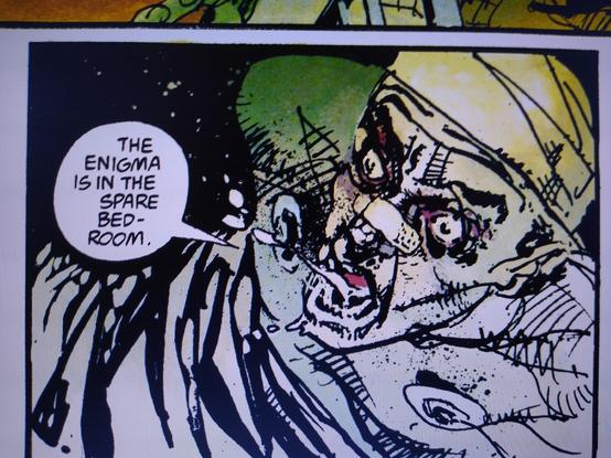 Man with bandage round head, blackened eyes, plaster across his nose, sits bolt up right in a hospital bed, having just been taken off life support. He says "The Enigma is in the spare bedroom."