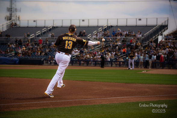 San Diego Padres third baseman Manny Machado, while on the run, throws sidearm to first base