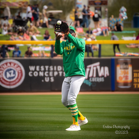 During warm ups, Oakland A’s outfielder Denzel Clarke watches the ball arrive at his open glove
