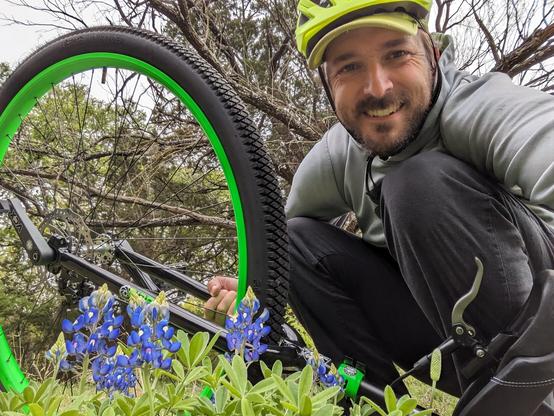 Selfie of a man with goofy smile with blue bones and a unicycle