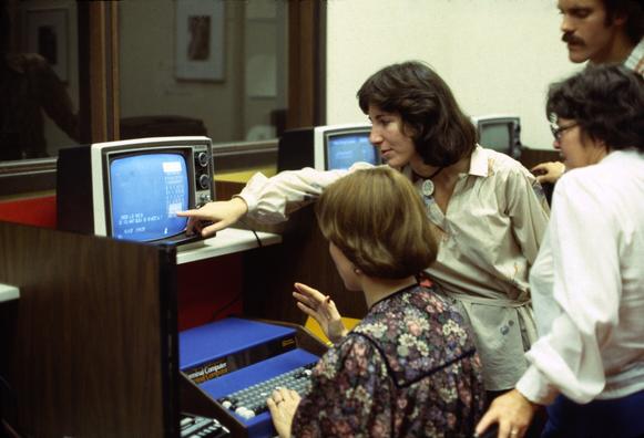 Annie Fox shows a Marin Computer Center member how to play checkers on a Processor Technology Sol-20 while David Fox looks on. Photo circa 1978.