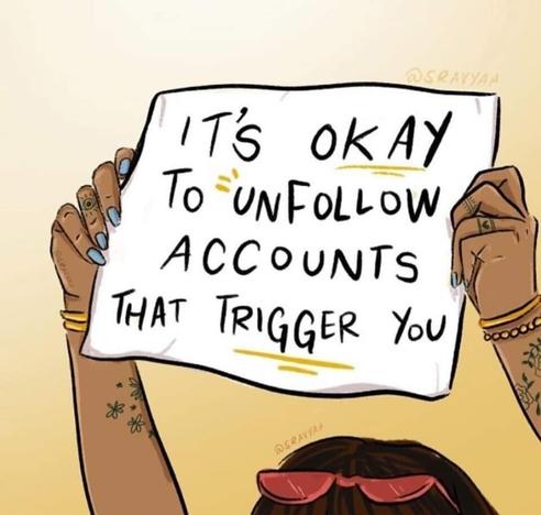 A person holds up a sign that says, "It's okay to unfollow accounts that trigger you."