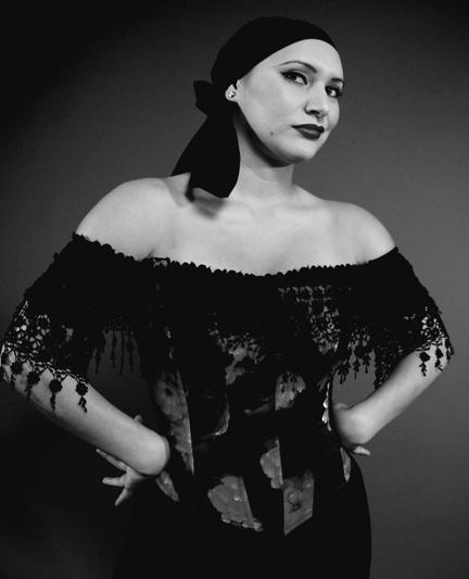 Model in Spanish attire in studio portrait. Black and white photo.