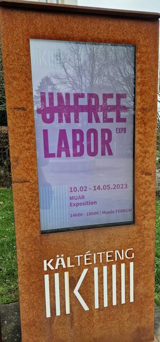 An electronic panel shows the information for "Unfree labour" exhibition in Kayl.