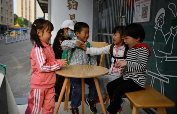Children play outside a cafe in Beijing. The population of China’s capital shrank last year for the first time in 19 years