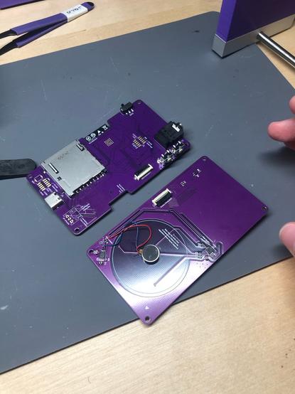 the other side! the electronics pcb has sd card slot, usb c, buttons, and a trs jack. the other pcb has a haptic motor!! they connect via a little ribbon connector