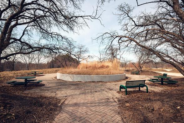 The image of the disused picnic nook, once built with good intentions for employee wellbeing, now stands as a symbol of a bygone era, juxtaposed against the busy unseen highway.