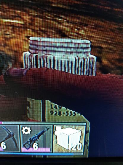 Screenshot of a hand holding a pill bottle with only a partial phone number visible reading "928-555-" from the game 7 Days to Die.