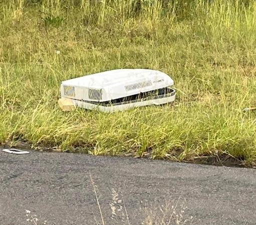 A caravan air conditioner in its natural habitat - on grass next to the road of Woy Woy Underpass
