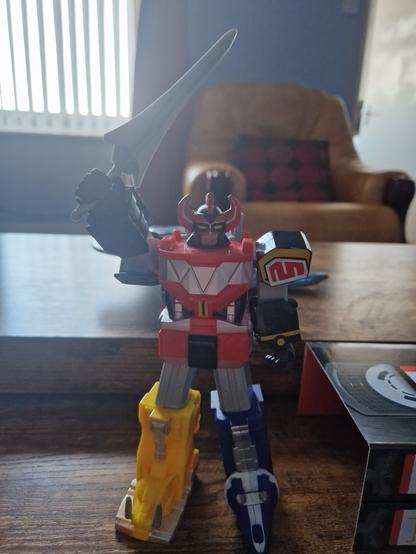 The mighty Dino Megazord holds it's power sword aloft, ready to take down another of Rita's menacing monsters!