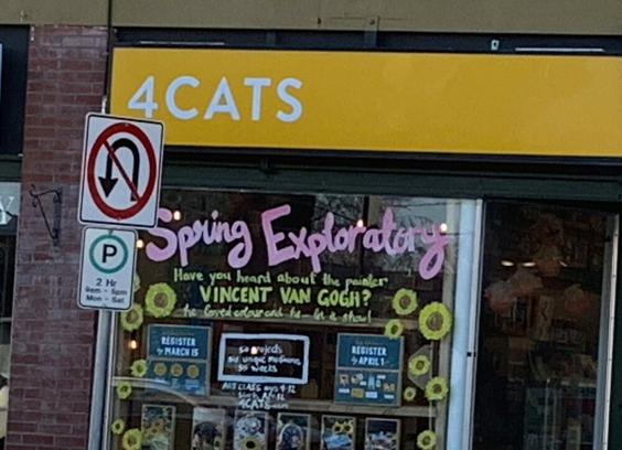 Shopfront window for 4CATS pottery studio painted with the words "Spring Exploratory" (in pink) and "Have you heard about the painter Vincent Van Gogh? He loved colour and he let it show!" (in yellow)