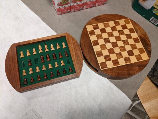 a round chess board, with a small set of pieces that pop out from the inside.