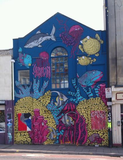 An underwater street art scene painted onto the side of a house in Stokes Croft, Bristol