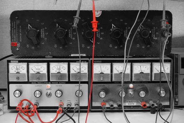 DC power supplies and a resistor decade box, with a red color pop