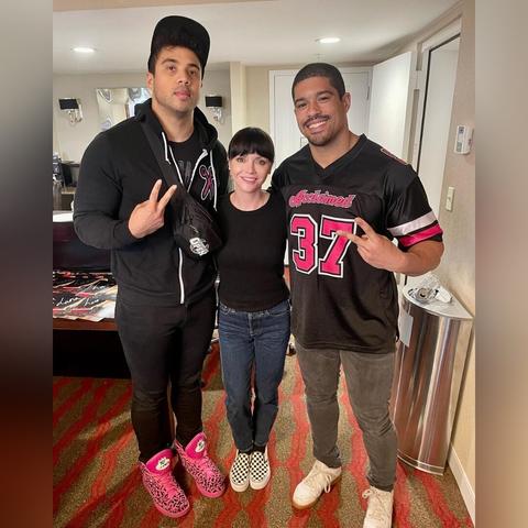 Christina Ricci poses with AEW's Platinum Max Caster and Anthony Bowens, collectively known as 'The Acclaimed'.