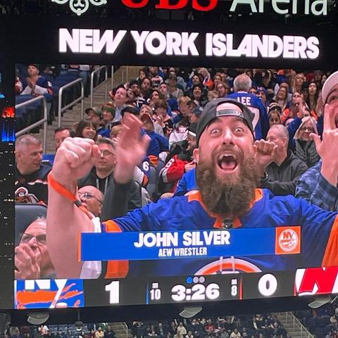 AEW pro wrestler John Silver appears on the UBS Arena Jumbotron.