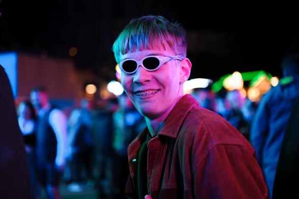 a man wearing sunglasses and a red jacket.