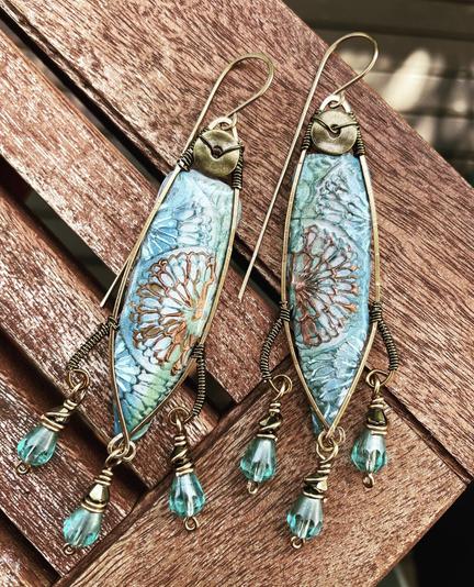 Blue and bronze earrings in a long fish like shape