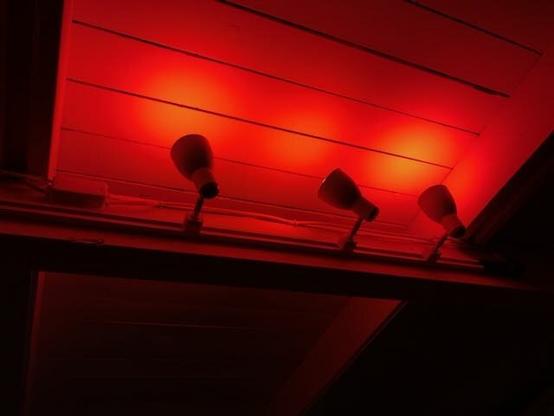 Red spotlights shining on a ceiling