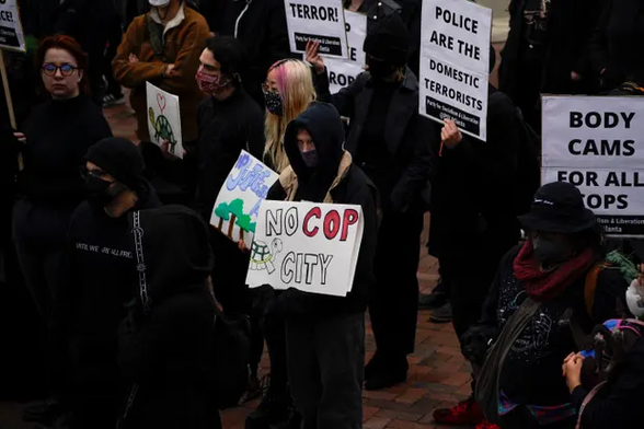 Protesters carrying "Stop Cop City" signs.