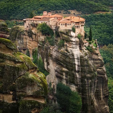 Meteora monastery in northern Greece. Monastery built high up on a sandstone pinnacle towering over the valley below.