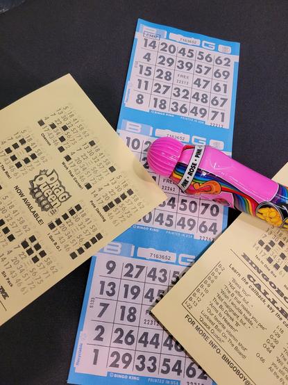 Bingo cards pink marker & card on black table