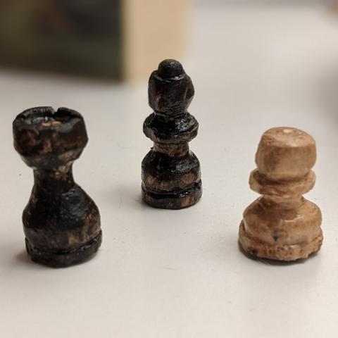 three carven chess pieces
