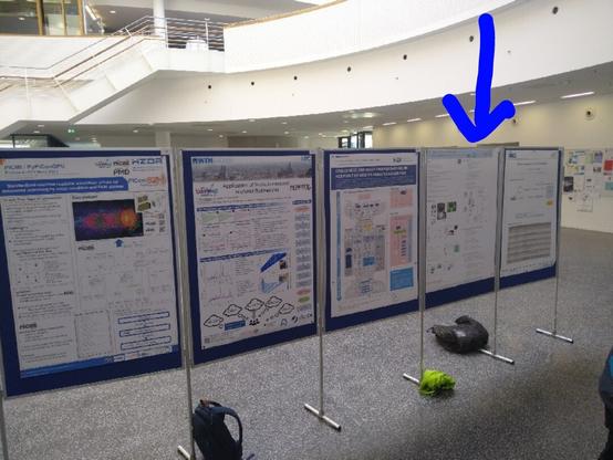 photo: poster walls, one is highlighted by a blue arrow