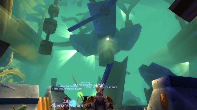 A screenshot from World of Warcraft inside of the dungeon Gnomeregan. It features a large towering metal structure with light pouring out of it.