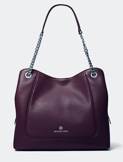 Handbag sale - this burgundy/brown bag has silver eyelets at the top comers & dips in the middle so that the front takes on a face shape - the eyelets look like staring-eyes (I’m a pareidoliac)