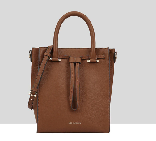 This is another handbag that has a look of suspicion. Handles are attached to gold bars  - the combination gives the look of top of head & eyes. The band that tightens the top, creates a long narrow nose. Hints of suspicion & possible relation to Clippy.