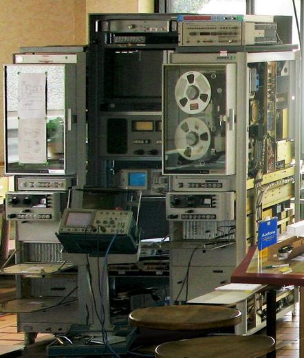A similar tower of electronics, looking like a complex yet meaningful mess of devices and cables. It's the FR-900 from the McMoon office.