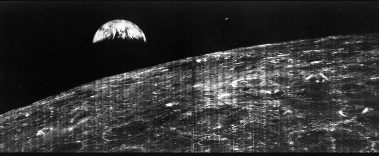 The first picture of earth from the moon. Black/white, striped from scanning (I guess), large moon surface at the bottom, smaller earth at the top.