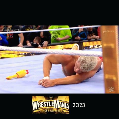 Cody Rhodes performing in 2023 WWE WrestleMania; A rubber chicken got thrown on him in the ring.