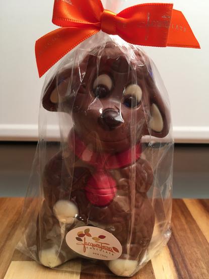 A chocolate little lamb wrapped in cellophane with an orange ribbon from Jacques Torres