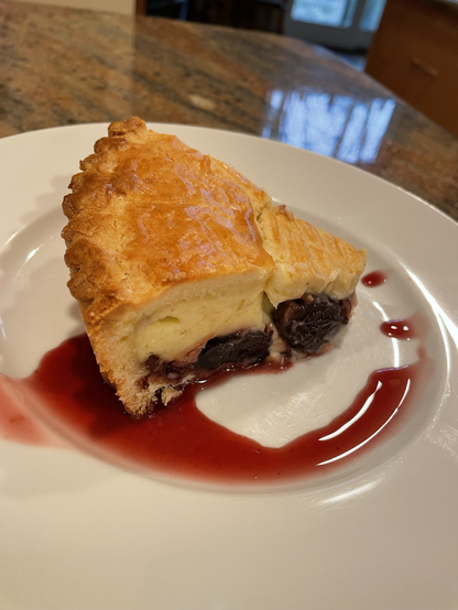 A slice of Gateau Basque, a tart filled with cherries and cream