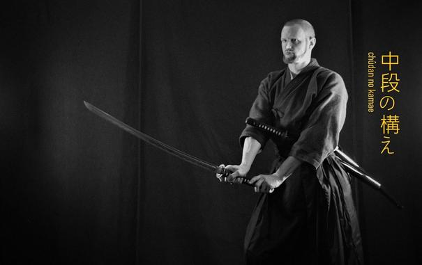 A person with a uchi-katana holding the blade in a normal chudan-kamae.