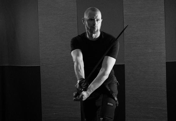A person with a uchi-katana holding its sword in seigan-kamae. A stance where the tip is a bit off-center to the side (good for defending while moving)
