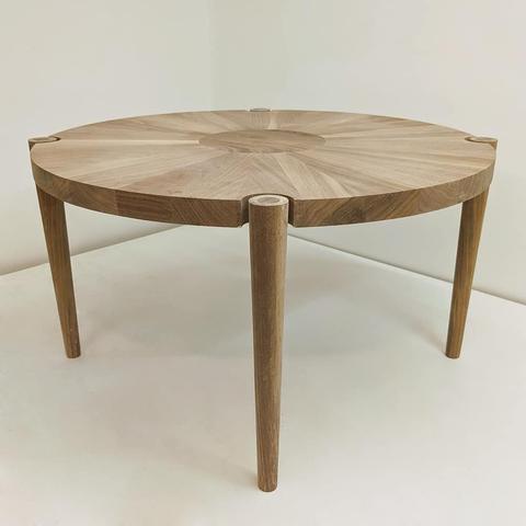 A round walnut coffee table.