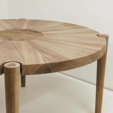 Close up of a round walnut coffee table.