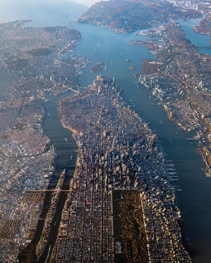 The Narrows: aerial photograph above Manhattan, showing Queens, Brooklyn, Jersey City, and Staten Island, with the Verrazzano-Narrows Bridge at the top of the photo.