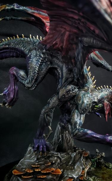 The same mini from the right side, showcasing more of the wings as well as the skin/scales of the creature's flank.