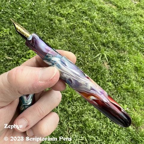 Barrel view of custom fountain pen, held in maker’s hand.