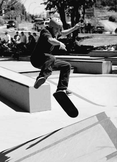Flip kick aerial skateboarding competition shot. Monochrome.