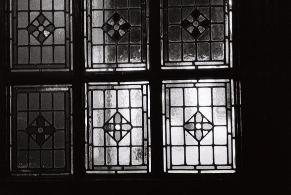 A black and white photo of a stained glass window in Dan Lowerey's pub in Cork City