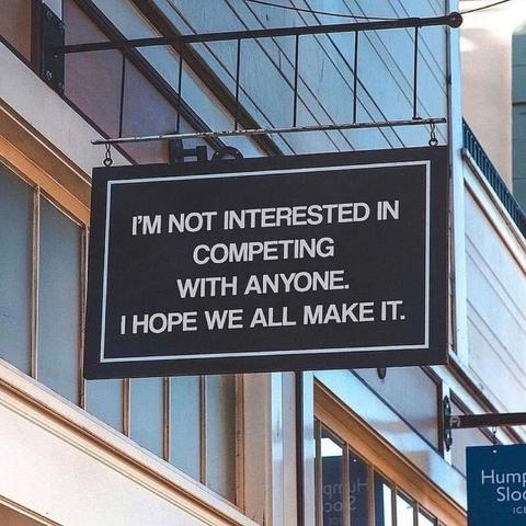 Sign that reads "I'm not interested in competing with anyone. I hope we all make it."