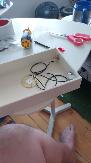 A piezo mic set up in a small wooden box. Also a very thick leg.