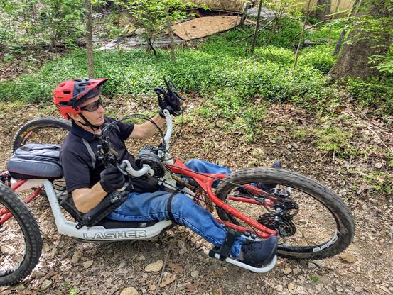 Adaptive mountain biker rider on a rocky trail