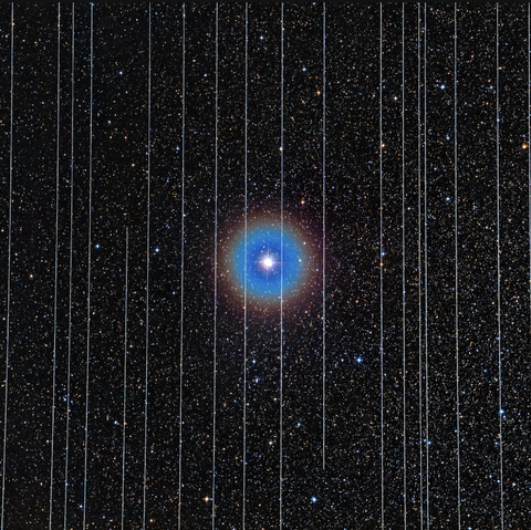 An image of the double star Albireo in the constellation Cygnus taken in 2019 was marred by two of its ten 2.5-minute exposures recording Starlink satellites moving across the field.Credit...Rafael Schmall/NOIRLab/National Science Foundation